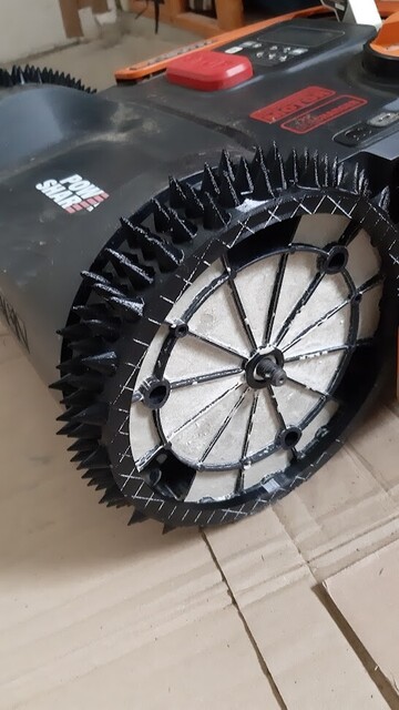 Cement-filled back wheels of the Landroid lawn mower.