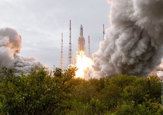 Clouds of steam and rocket exhaust surround Ariane 5 as it lifts off on flight VA260