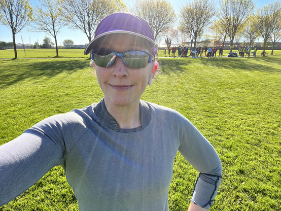 Pale white lady in running gear & sunglasses before Parkrun
