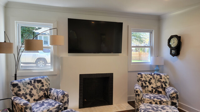 Masonry TV wiring and installation over a masonry fireplace. Surge protected outlet was wired from the attic.