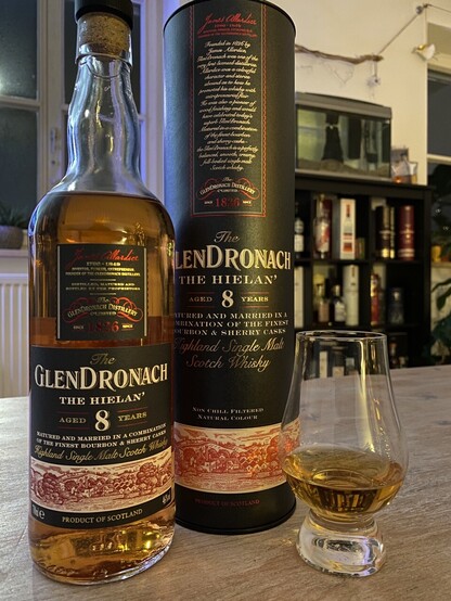 Bottle of GD8 with black tube and glass. 