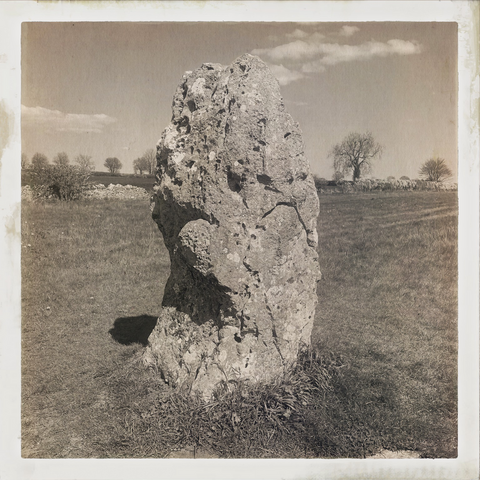 a mono photo of the hawk stone - a presumed neolithic standing stone located on its own in a field in The Cotswolds - lots of folklore and mystery attached to this stone but no archaeological facts