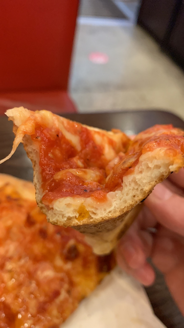 The pizza dough is not too heavy and has some air bubbles in it.