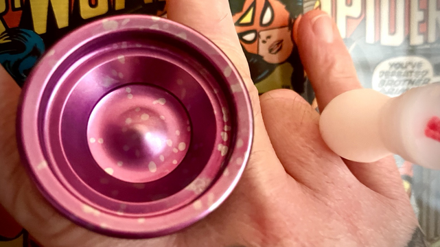 Fuchsia ￼Lunar Exlipce yo-yo set up for Astro style freehand play. Spider-woman comics in the background. 
