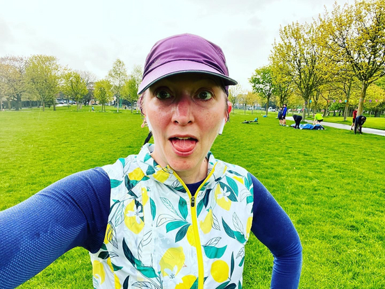 Pale white lady in wet weather running gear after Parkrun