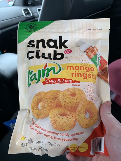 A bag of Snak Club brand Vegan Tajin Mango gummy rings. 