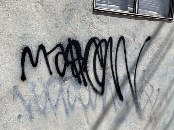 A tag that says "Masow" (or maybe something else). The letters appear connected in a oneliner style. The word gets bigger and more exagerated as it goes. 
