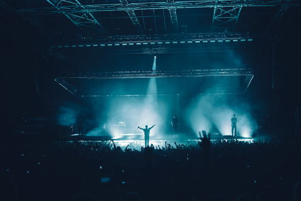 Status, a person alone on stage admired by all in the audience,  image by Sebastian Ervi / Unsplash