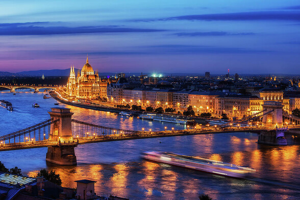 Budapest city at blue hour twilight with illuminated Chain Bridge and Hungarian Parliament on Danube River, tranquil evening cityscape.