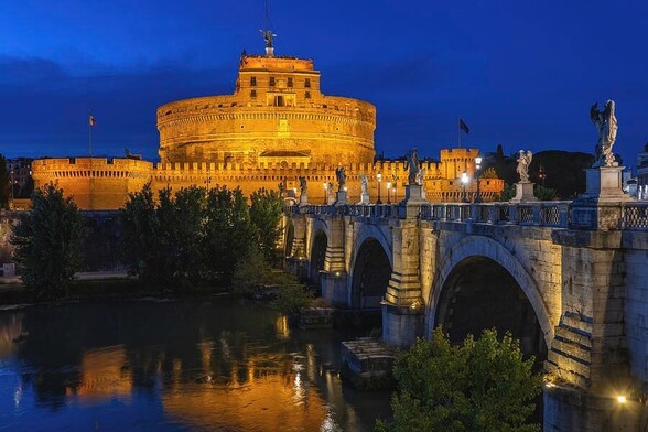 City of Rome by night in Italy. Castle of the Holy Angel (Castel Sant Angelo), an ancient Mausoleum of Hadrian and St Angelo Bridge over Tiber River.