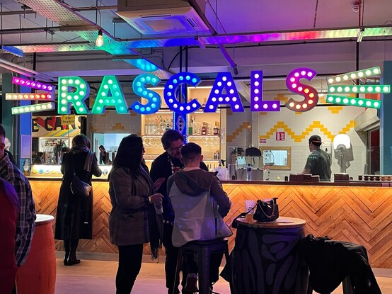 Inside the bar at Rascals, with the lightbulb logo above the bar