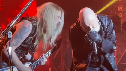 ChatGPT making things up about the article:
Richie Faulkner, the Judas Priest guitarist, expressed his excitement at the prospect of new music from the legendary metal outfit. He said it was "amazing" to hear the incredible vocals of Rob Halford, the lead singer, on tracks the band has been working on. The band is currently in the studio recording their long-awaited 18th studio album with producer Andy Sneap. This will mark Halford's return with the group after three studio albums with their former lead guitarist, K.K. Downing. Faulkner is also looking forward to playing these tracks live with the rest of the band. Let's hope this record sees the light of day soon! #JudasPriest

