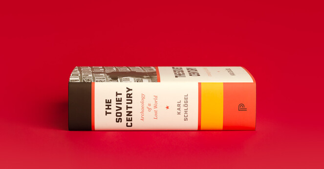 Side view of spine of The Soviet Centory laying on its side against a red background. Spines has a series of color rectangles of varying size in black, red, cream, red, yellow, and red. 