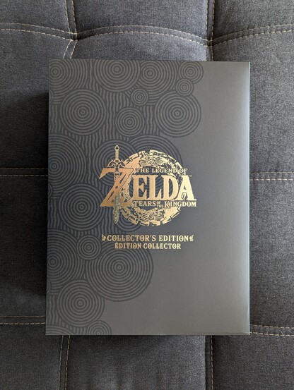 Bild der Collectors-Edition zu The Legend of Zelda,:Tears of the Kingdom.
Schwarzer Karton mit goldenem Emblem und Aufschrift 