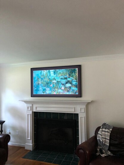 Samsung Frame TV installed over a fireplace.