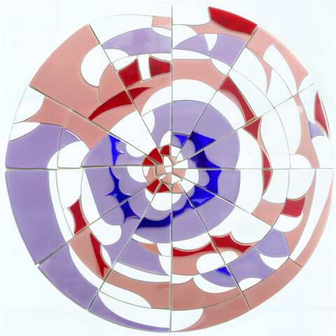 A circular mosaic with red and blue irregular tiles arranged in a somewhat circular fashion. 