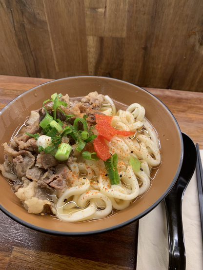 Chiki Chiki Beef Soup Noodle topped with spring onions and ginger slices