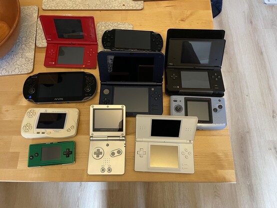 A selection of handheld games consoles
