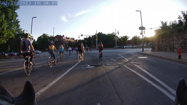 Cyclists ride through the last of the sunlight in downtown Baltimore.