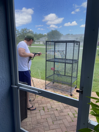 Empty rat cage outside while Jason takes the pressure washer to it. 