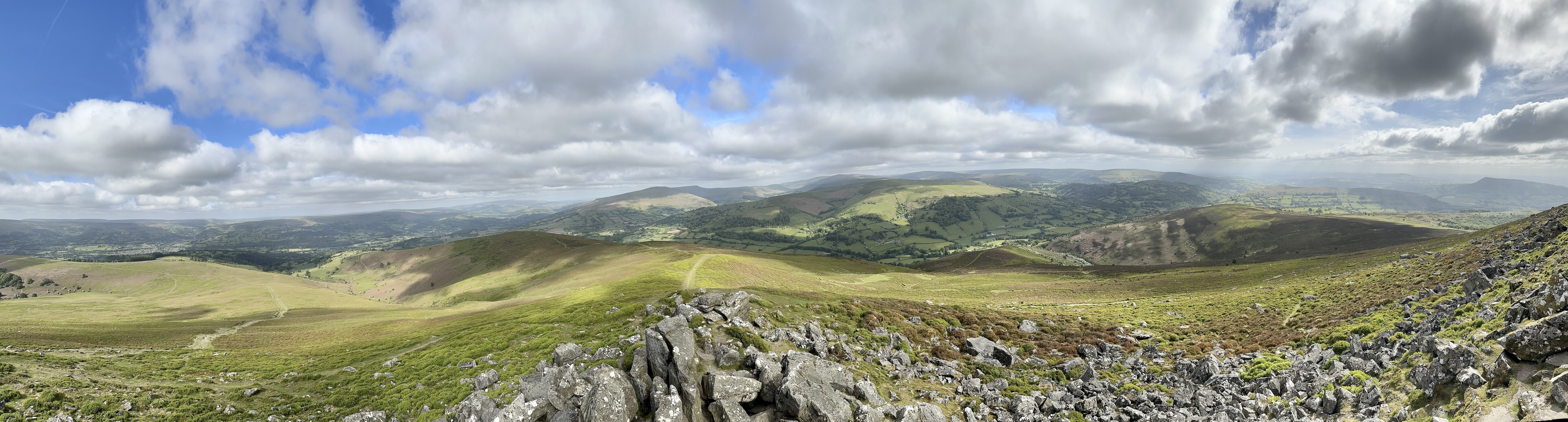 A panoramic view of hills, valleys, and grass as far as can be seen.