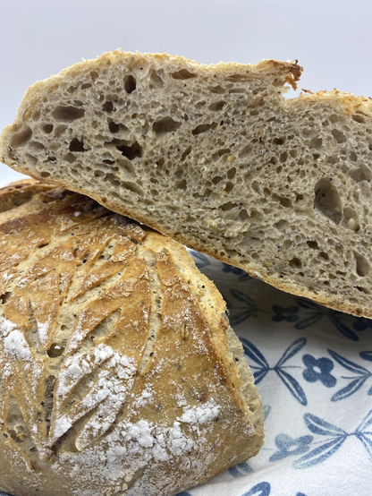 Loaf cut in half, placed one half on the other at an angle, displaying the crumb
