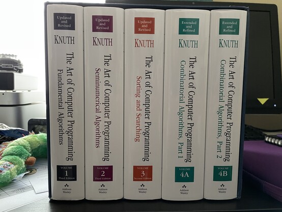 A pristine box set of Knuth’s “The Art of Computer Programming”, volumes 1 through 4B. Not shown, me being very happy with them. 