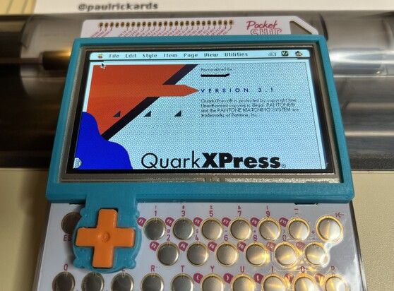 A PocketCHIP handheld computer showing a emulated Mac running System 7.5.5. On the screen is the splashscreen for Quark XPress 3.1.