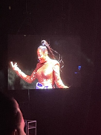 View of large stage monitor showing close up of Janet Jackson singing
