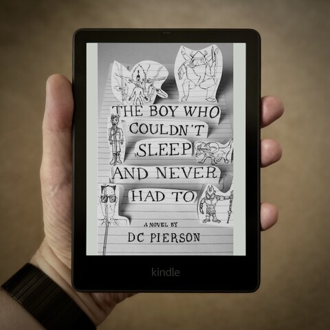 Hand holding a Kindle Paperwhite showing the cover of the novel The Boy Who Couldn't Sleep and Never Had To by D.C. Pierson