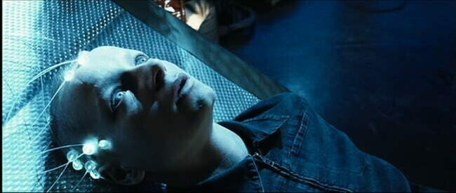 Actress Samantha Morton as one of  the 3 Precogs in the movie Minority Report, floating in a pool filled with water, hooked up to a computer network