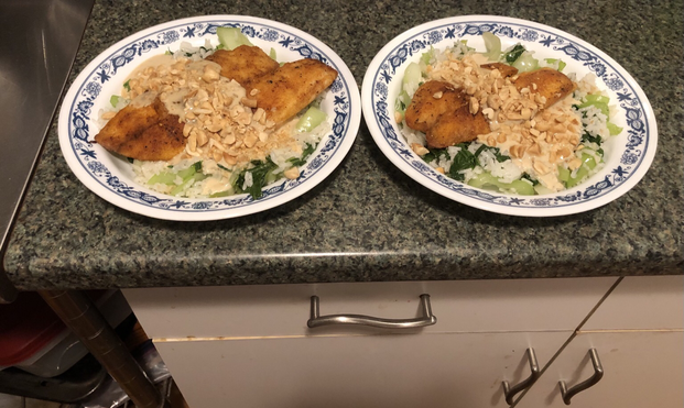 Plated dish. Togarashi seasoned tilapia on a bed of rice and sautéed Bok Choy. Sesame-Yuzu sauce drizzled on top of the tilapia. Garnished with peanuts.