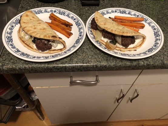 Plated dish. Pocketless pita slathered with garlic yogurt and topped with 3 meatballs, roasted poblano, and onion. Roasted carrot fries. Not pictured: harissa mayo for dipping.
