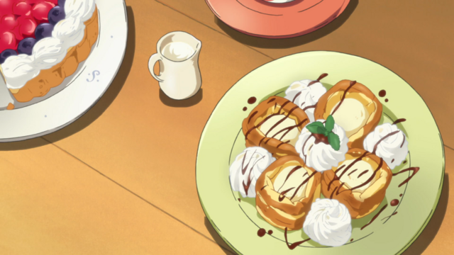 Two plates with elaborate pastries.