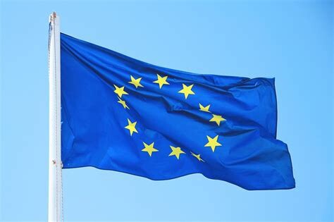 A European Union flag flutters in the breeze at the top of a flag-pole.