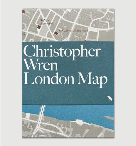 Immagine della "Christopher Wren London Map" con un foglio di carta blu opaca seduto al centro della mappa piegata con grande testo in bianco "Christopher Wren London Map"), che rivela dietro il Tamigi Rives e strada segnata in bianco e gli edifici in grigio.