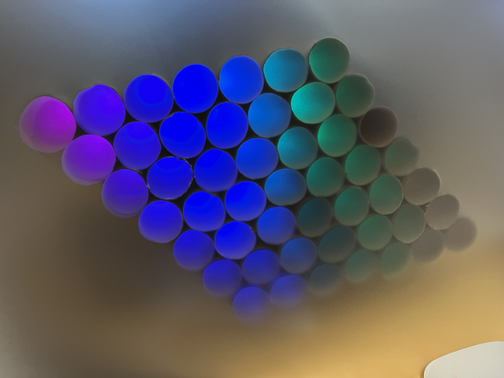 A LED strip project in a diamond shape with a diffuser in front of it