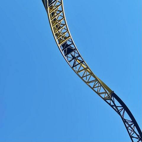 Lost gravity track against a blue sky. Four sections of track alternate in solid black and yellow colour.