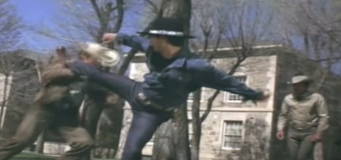 Tom Laughlin as Billy Jack in mid-kick. In this scene he is using his martial arts skills against multiple bigoted jerks in a town square in Arizona.