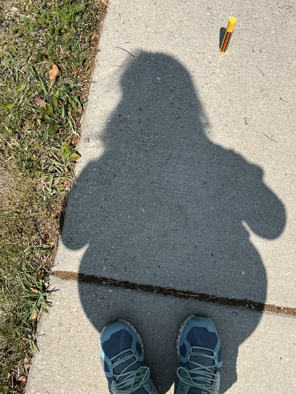 My short shadow at the summer solstice on the sidewalk 