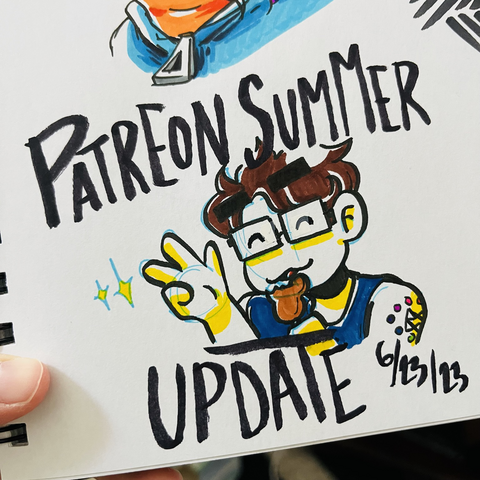 A photo of a drawing in a sketchbook. It’s a cartoon drawing of Emily, a woman with brown hair, glasses, wearing a blue tank top and eating a Mickey ice cream bar. She has her eye closed and is holding up a peace sign. The text around her reads “Patreon Summer Update 6/23/23”