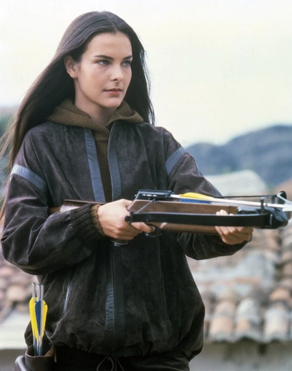 Carole Bouquet with a crossbow