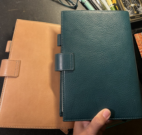 Backs of the deep teal and apricot A5 leather planner covers by Moterm