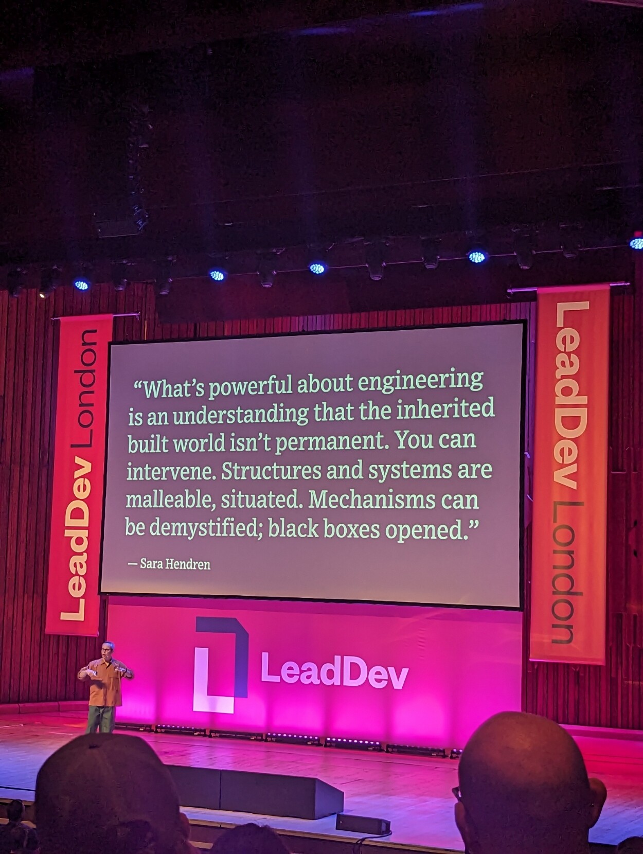 David Yee on the stage at LeadDev London, in front of a slide quoting Sara Hendren "What's powerful about engineering is an understanding that the inherited built world isn't permanent. You can intervene. Structures and systems are malleable, situated. Mechanisms can be demystified; black boxes opened."