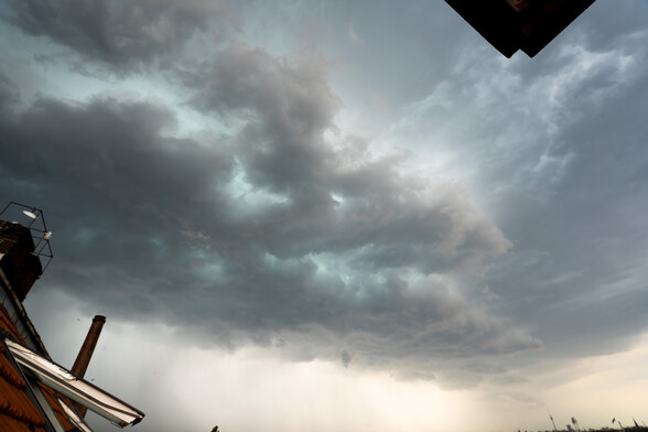A thick raincloud hovering in the sky.