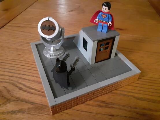 Batman and Superman preparing to fight on the roof of Gotham PD (a LEGO creation)