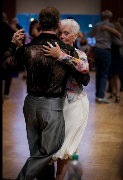 A man and woman dancing #argentinetango.  The dancers hold each other in close embrace.  Both dancers listen intently to the music with deep concentration on their faces.  A dance partnership can also be woman-and-woman, or man-and-man.  All ages of people are capable of dancing #tango.