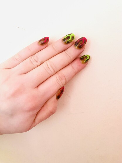 New acrylic nails. Showing left hand tortoiseshell background, with alternating neon pink and green flames 