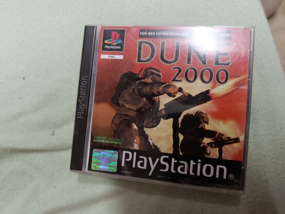 A German PAL copy of "Dune 2000" by Westwood Studios for the PSone. The cover shows two heavily armored Harkonnen soldiers blasting their rifles/miniguns.