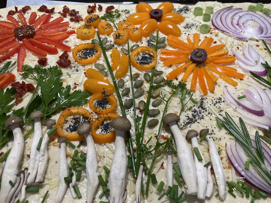 As previously described, unbaked gardens cape focaccia. The flower stems are chives with pumpkin seeds for foliage.
